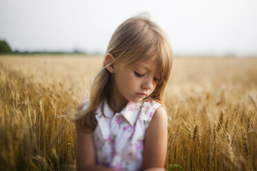 Upset girl standing against sky in farm - CAVF38295