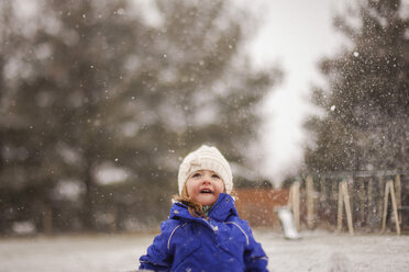 Happy girl enjoying snowfall - CAVF38366