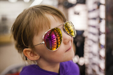 Close-up of girl wearing sunglasses at shop - CAVF38374