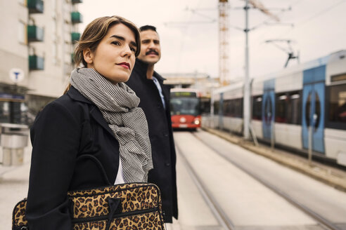 Young woman and man waiting for tram at station - MASF03808