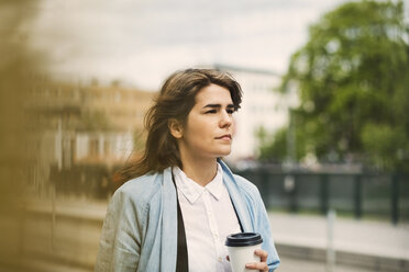 Young woman looking away at tram station - MASF03814