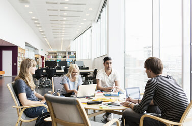 Young university friends studying together in library - MASF03845