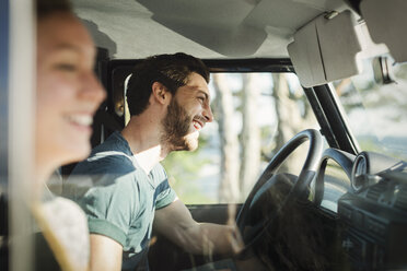 Side view of happy couple enjoying road trip - MASF03935