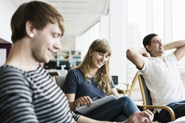 Smiling university students studying at library - MASF03937