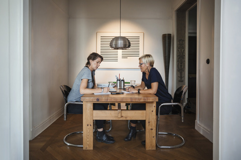 Side view of industrial designers working at home office stock photo