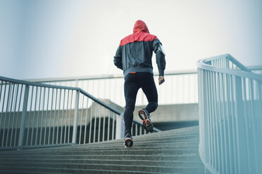 Rear view of man running on steps - MASF04069