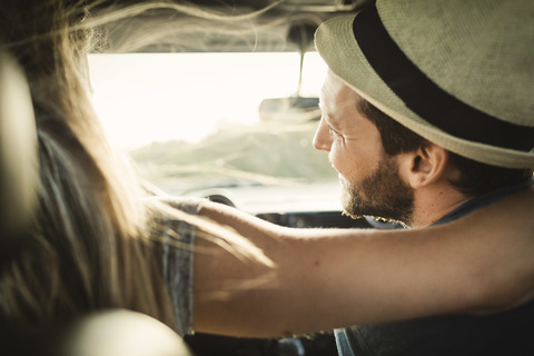 Rear view of affectionate couple on road trip stock photo