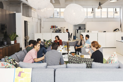 Multi-ethnic business people discussing project in modern office lobby stock photo