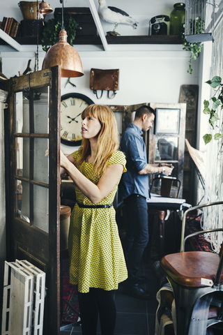 Mid adult woman and man working in interior design shop stock photo