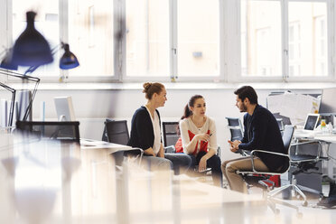 Mid adult businesswoman with colleagues having discussion in office - MASF04180