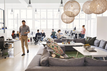 Modern office lobby with business people working in background - MASF04183