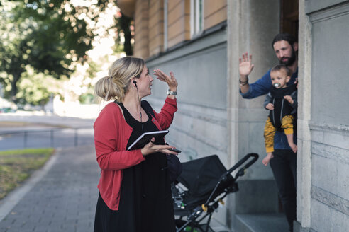 Mid adult mother waving family while leaving for work - MASF04198