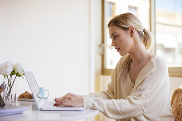 Woman using laptop at home - EBSF02389