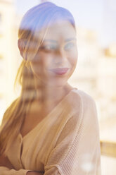 Blonde woman looking out of window - EBSF02394