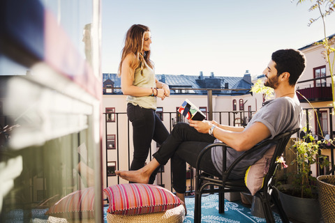 Glückliches Paar plant Urlaub auf dem Balkon, lizenzfreies Stockfoto