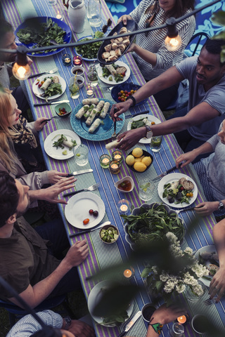 High angle view of friends having food at dining table in yard stock photo