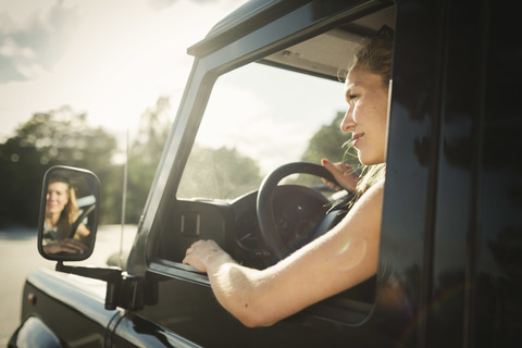 Cropped image of woman looking away while driving car stock photo