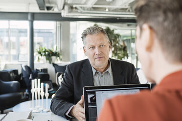 Businessman looking at colleague during meeting - MASF04482