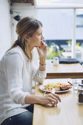 Thoughtful woman having lunch at cafe - MASF04527