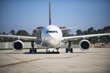 Airplane on runway against clear blue sky - CAVF38564