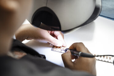 Cropped image of technician making circuit board in industry - CAVF38585