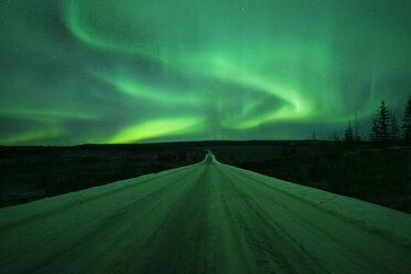 Scenic view of aurora borealis over snow covered road - CAVF38644