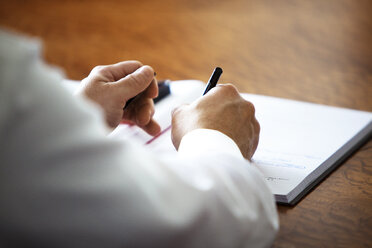 Man writing in notebook - CAVF38835