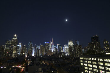 Low angle view of illuminated cityscape against sky at night - CAVF38896