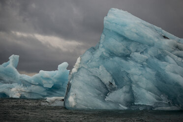 Iceberg in sea against cloudy sky - CAVF38989