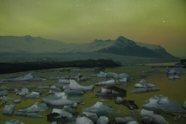 Scenic view of icebergs in sea against snowcapped mountain - CAVF38996