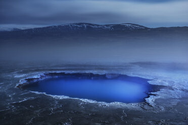 Hot spring in volcanic landscape against sky during foggy weather - CAVF39018