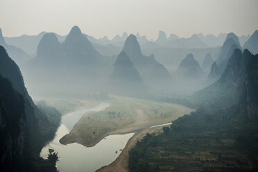 River flowing against mountain during foggy weather - CAVF39049