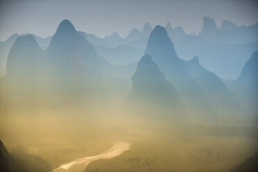 Scenic view of mountain against dramatic sky during foggy weather - CAVF39051