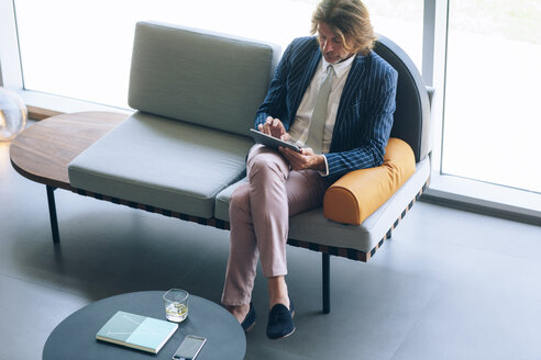 Midsection von reifen Geschäftsmann mit Tablet-Computer im Büro - CAVF39129