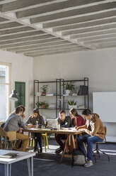 Students studying at table by window in classroom - CAVF39266