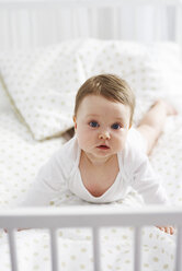 Portrait of baby lying in crib - ABIF00325