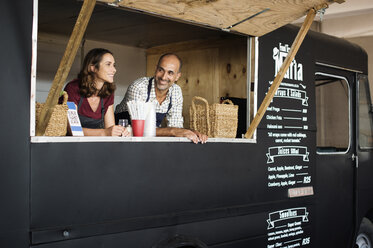 Owners standing in food truck - CAVF39476