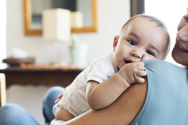 Mutter schaut sich ihr Baby an, während sie zu Hause sitzt - CAVF39509