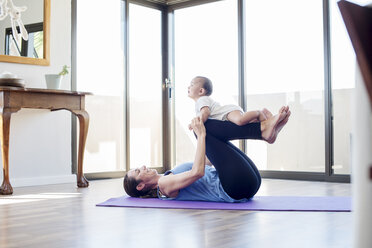 Side view of mother playing with son at home - CAVF39529