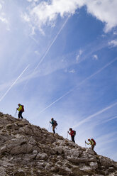 Hikers walking across mountain against sky - CAVF39692