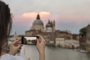 Ausgeschnittenes Bild einer Frau, die Santa Maria della Salute bei Sonnenuntergang fotografiert - CAVF39700