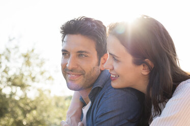 Side view of smiling couple against sky on sunny day - CAVF39823