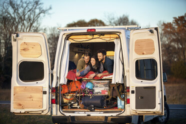 Friends talking selfie while lying on bed in camper van - CAVF39937