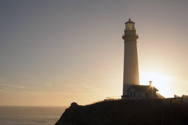 Low angle view of lighthouse on cliff against sky - CAVF40016