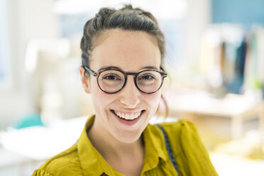 Portrait of happy young woman wearing glasses - MOEF01023