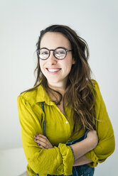 Portrait of smiling young woman wearing glasses - MOEF01025