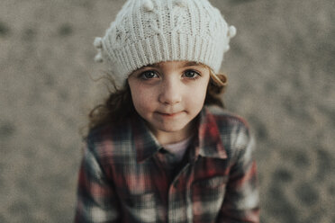 High angle portrait of cute girl wearing knit hat while standing on field - CAVF40165