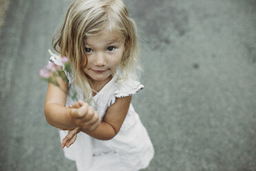 High angle portrait of cute girl standing on country road - CAVF40184