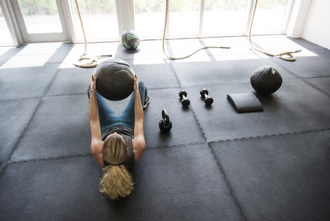 Hoher Winkel Ansicht der Athlet mit Medizinball in Crossfit Fitnessstudio trainieren, lizenzfreies Stockfoto