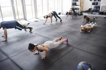 High angle view of athletes doing push-ups in crossfit gym - CAVF40278